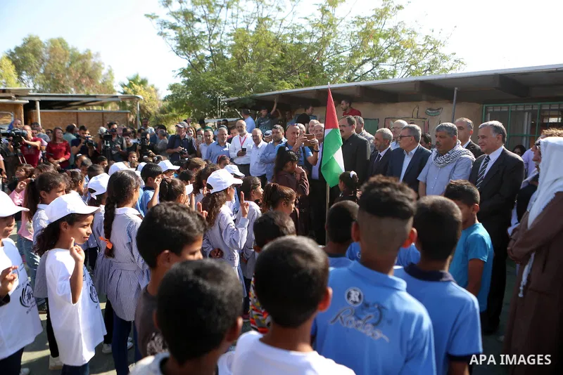 Palestinian schoolchildren stand in a line on the first day of a new school year, at Khan al-Ahmar's school at the Palestinian Bedouin village of Khan al-Ahmar, east of Jerusalem in the occupied West Bank on July 16, 201...