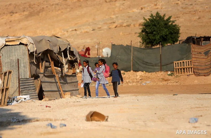 Palestinian schoolchildren return back to their school in the morning of the first day of the new year study, at Khan al-Ahmar's school at the Palestinian Bedouin village of Khan al-Ahmar, east of Jerusalem in the occupi...