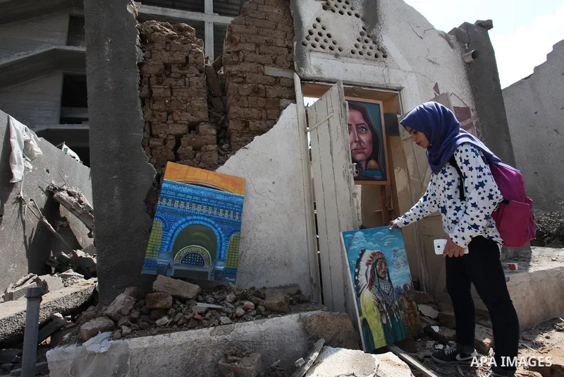 Palestinian artists take part in an exhibition against the bombing of the Arts and Crafts Village that was damaged in an Israeli airstrike on the Gaza City, on July 16, 2018. Photo by Mahmoud Ajour