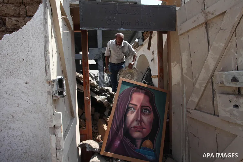 Palestinian artists take part in an exhibition against the bombing of the Arts and Crafts Village that was damaged in an Israeli airstrike on the Gaza City, on July 16, 2018. Photo by Mahmoud Ajour