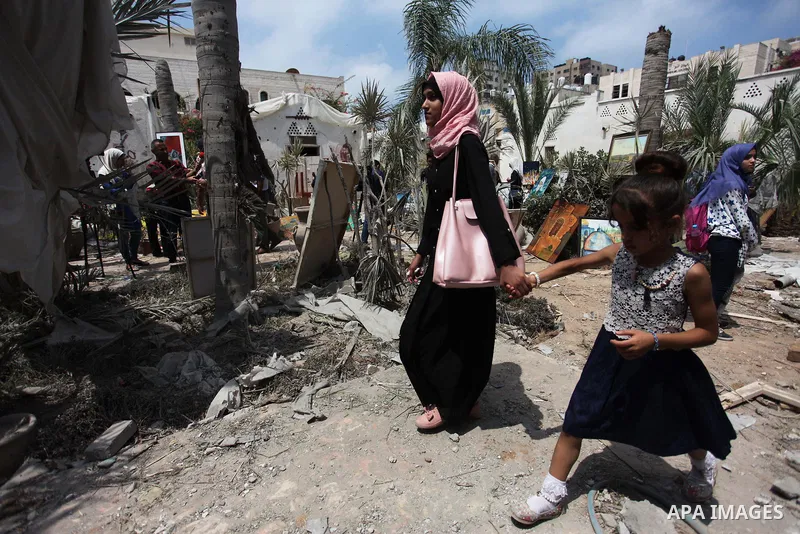 Palestinian artists take part in an exhibition against the bombing of the Arts and Crafts Village that was damaged in an Israeli airstrike on the Gaza City, on July 16, 2018. Photo by Mahmoud Ajour