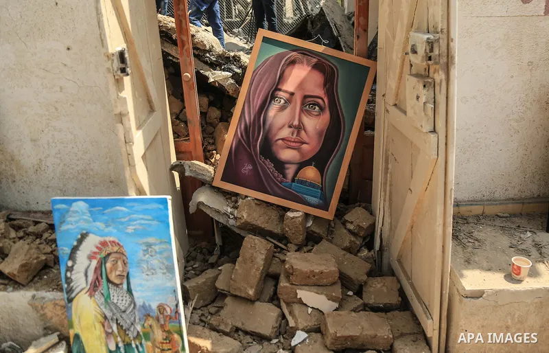 Palestinian artists take part in an exhibition against the bombing of the Arts and Crafts Village that was damaged in an Israeli airstrike on the Gaza City, on July 16, 2018. Photo by Dawod Abo Elkass