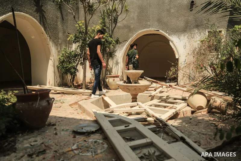 Palestinian artists take part in an exhibition against the bombing of the Arts and Crafts Village that was damaged in an Israeli airstrike on the Gaza City, on July 16, 2018. Photo by Dawod Abo Elkass