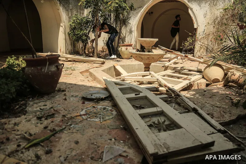 Palestinian artists take part in an exhibition against the bombing of the Arts and Crafts Village that was damaged in an Israeli airstrike on the Gaza City, on July 16, 2018. Photo by Dawod Abo Elkass