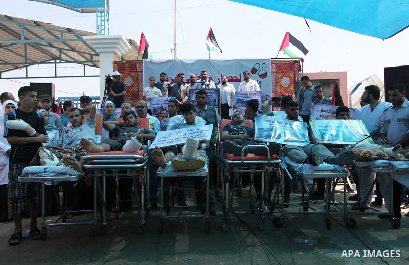 Palestinians who were wounded by Israeli troops during clashes at Israeli-Gaza border, take part in a protest to demand their rights to travel for treatment and against the siege on the Gaza Strip, at Erez crossing, in t...