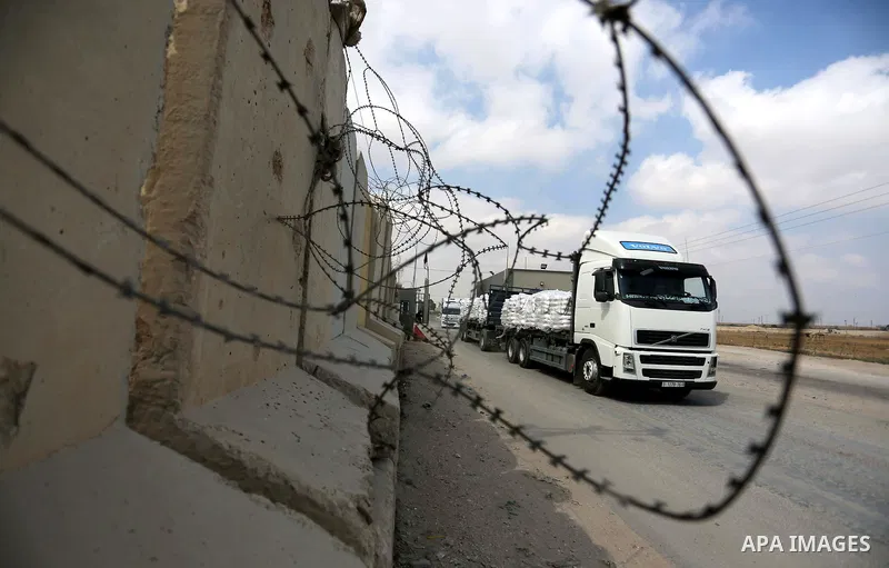 A truck is seen at the gate of the Kerem Shalom crossing, the main passage point for goods entering Gaza, in the southern Gaza Strip town of Rafah, on July 17, 2018. Israel further tightened its blockade of the Gaza Stri...