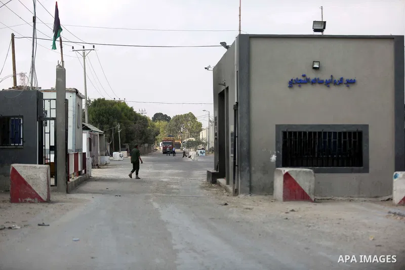 Palestinian security forces stand at the gate of the Kerem Shalom crossing, the main passage point for goods entering Gaza, in the southern Gaza Strip town of Rafah, on July 17, 2018. Israel further tightened its blockad...
