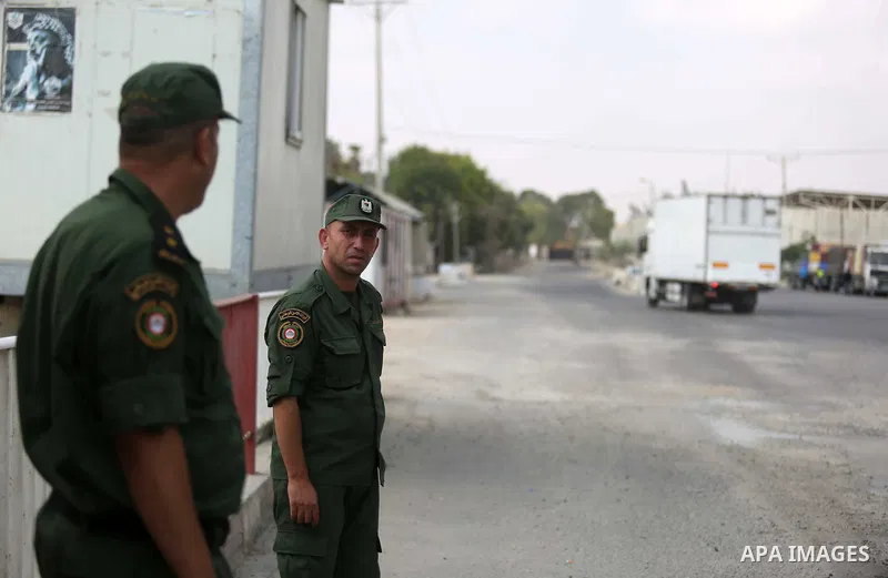 Palestinian security forces stand at the gate of the Kerem Shalom crossing, the main passage point for goods entering Gaza, in the southern Gaza Strip town of Rafah, on July 17, 2018. Israel further tightened its blockad...