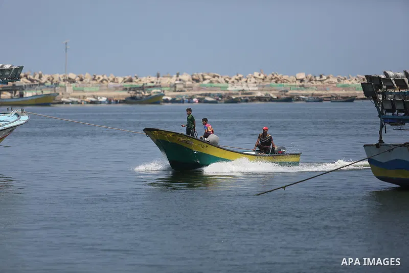 Palestinian fishermen ride their boat at the seaport of Gaza City on July 17, 2018, while the fishing zone enforced by Israel off the Gaza Strip was also reduced from six nautical miles to three. Israel tightened its blo...
