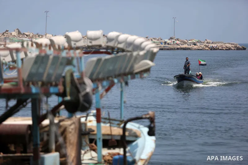 Palestinian fishermen ride their boat at the seaport of Gaza City on July 17, 2018, while the fishing zone enforced by Israel off the Gaza Strip was also reduced from six nautical miles to three. Israel tightened its blo...