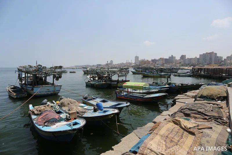 Palestinian fishermen ride their boat at the seaport of Gaza City on July 17, 2018, while the fishing zone enforced by Israel off the Gaza Strip was also reduced from six nautical miles to three. Israel tightened its blo...