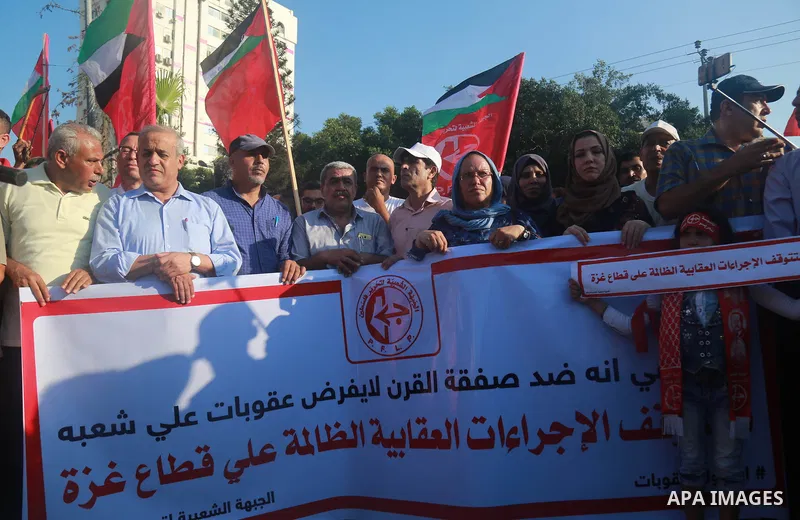 Palestinian supporters of the Popular Front for the Liberation of Palestine (PFLP) take part in a protest demanding to lift the sanctions on Gaza Strip, in Gaza city on July 18, 2018. Photo by Abed Abu Ryash ​