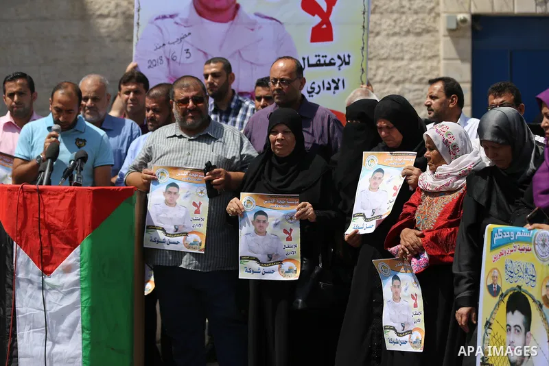 Palestinians take part in a protest to show solidarity with Hassan al-Shobaki who is in hunger strike at Israeli jails, in front of the high commissioner for human rights headquarters, in Gaza city, on July 19, 2018. Pho...