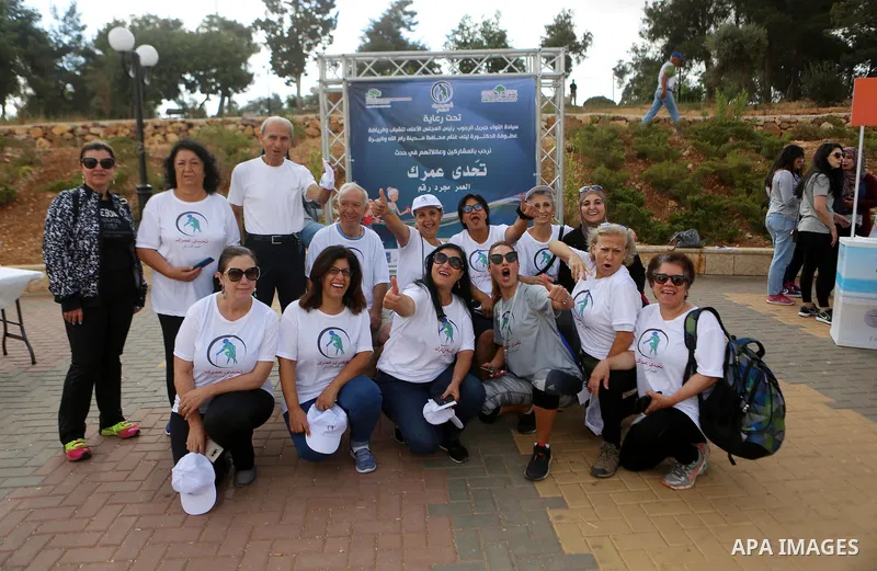 Palestinians take part in the challenge of walking, under the title: "Challenge your age" in the West Bank city of Ramallah, on July 20, 2018. Photo by Shadi Hatem