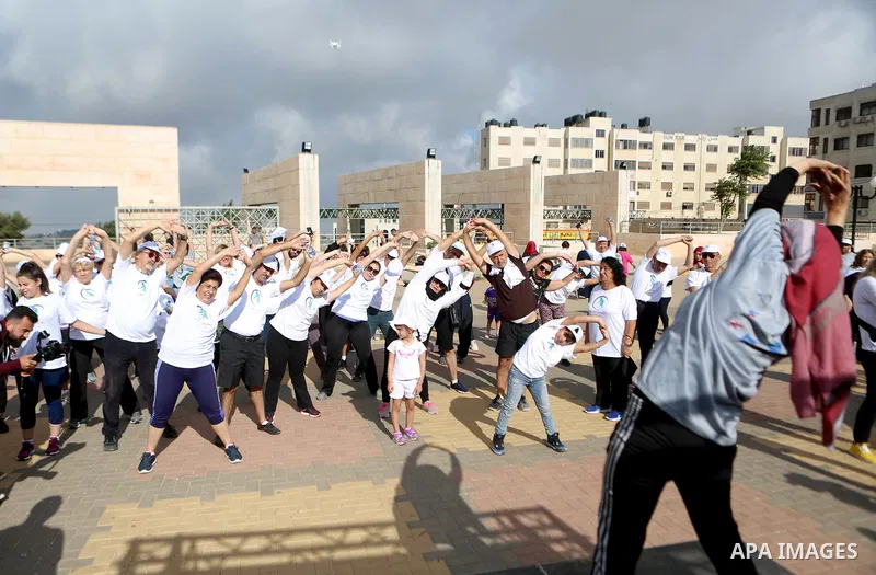 Palestinians take part in the challenge of walking, under the title: "Challenge your age" in the West Bank city of Ramallah, on July 20, 2018. Photo by Shadi Hatem