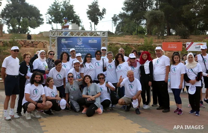 Palestinians take part in the challenge of walking, under the title: "Challenge your age" in the West Bank city of Ramallah, on July 20, 2018. Photo by Shadi Hatem