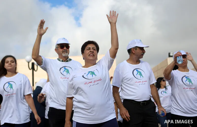 Palestinians take part in the challenge of walking, under the title: "Challenge your age" in the West Bank city of Ramallah, on July 20, 2018. Photo by Shadi Hatem