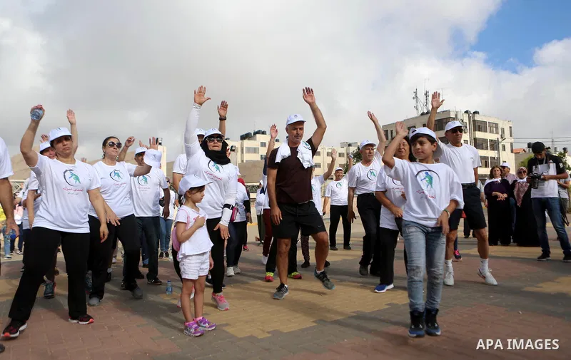 Palestinians take part in the challenge of walking, under the title: "Challenge your age" in the West Bank city of Ramallah, on July 20, 2018. Photo by Shadi Hatem
