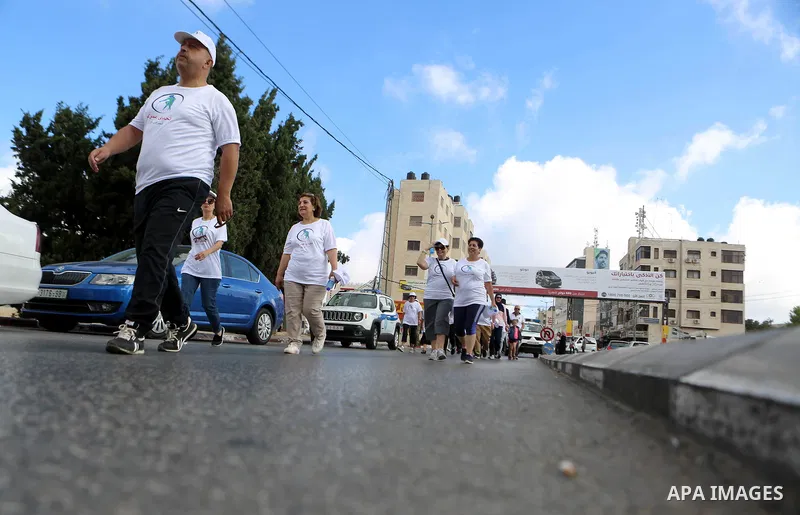 Palestinians take part in the challenge of walking, under the title: "Challenge your age" in the West Bank city of Ramallah, on July 20, 2018. Photo by Shadi Hatem