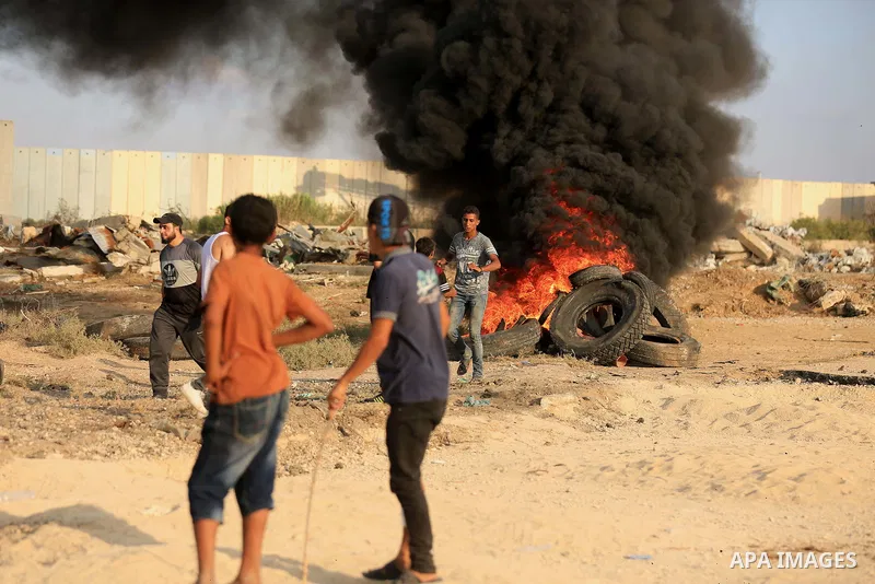 Palestinian protesters gather during clashes with Israeli troops in tents protest where Palestinian demand the right to return to their homeland at the Israel-Gaza border, in east of Gaza City on July 20, 2018. Photo by...