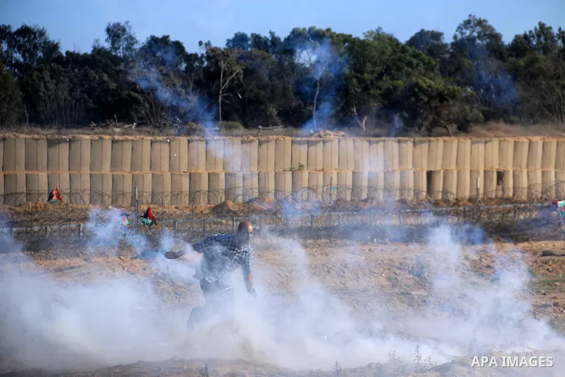Palestinian protesters gather during clashes with Israeli troops in tents protest where Palestinian demand the right to return to their homeland at the Israel-Gaza border, in al-Bureij in the center of Gaza Strip on July...