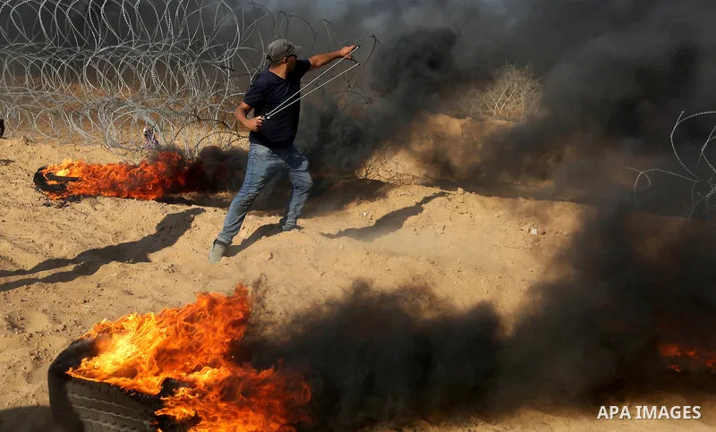 Palestinian protesters gather during clashes with Israeli troops in tents protest where Palestinian demand the right to return to their homeland at the Israel-Gaza border, in Khan Younis, in the southern Gaza Strip on Ju...