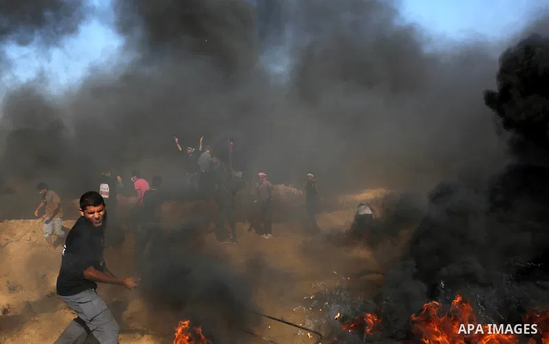 Palestinian protesters gather during clashes with Israeli troops in tents protest where Palestinian demand the right to return to their homeland at the Israel-Gaza border, in Khan Younis, in the southern Gaza Strip on Ju...