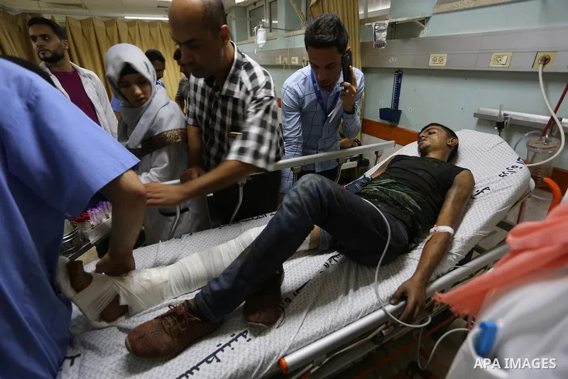 A Palestinian man who was wounded by Israeli troops during clashes at the Israel-Gaza border, in a tent city protest where Palestinians demand the right to return to their homeland, receives treatment at a hospital in Kh...