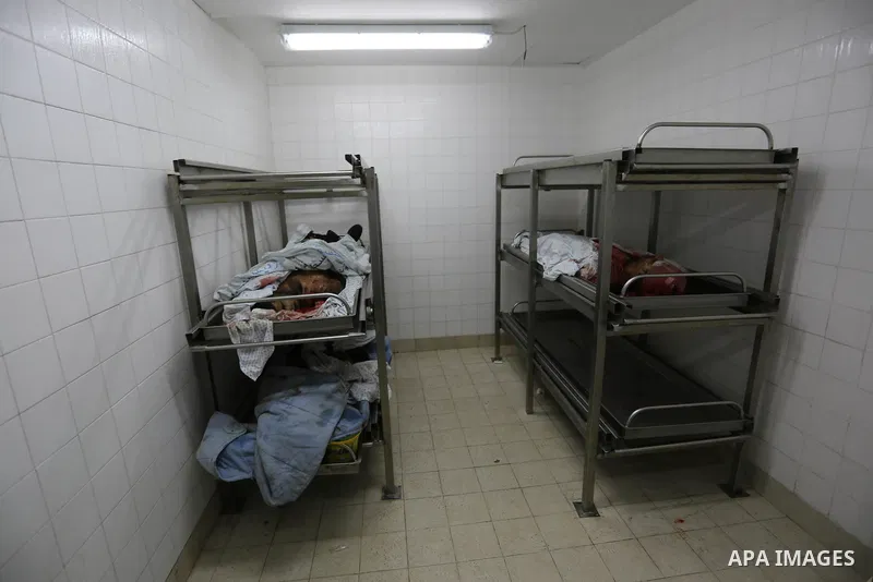 The Bodies of Palestinian Hamas members, who were killed by Israeli bombardment during clashes near the border with Israel, are seen at a hospital in Khan Yunis in the southern Gaza Strip on July 20, 2018. Photo by Ashra...