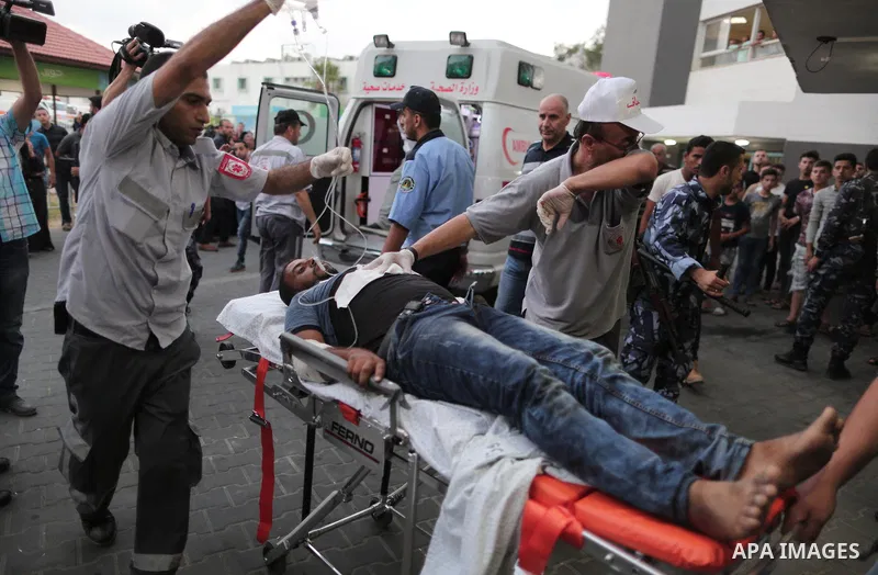 A Palestinian man who was wounded by Israeli troops during clashes at the Israel-Gaza border, in a tent city protest where Palestinians demand the right to return to their homeland, receives treatment at al-Shifa hospita...