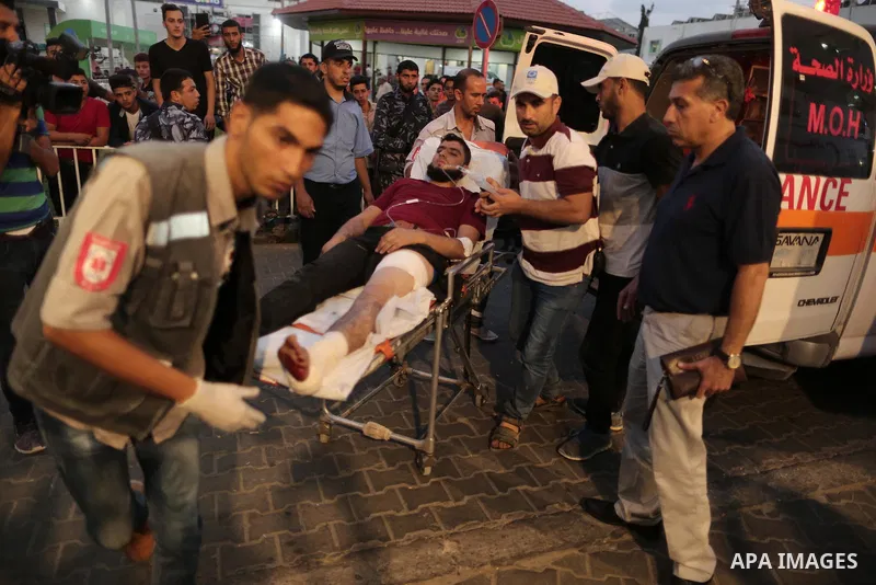 A Palestinian man who was wounded by Israeli troops during clashes at the Israel-Gaza border, in a tent city protest where Palestinians demand the right to return to their homeland, receives treatment at al-Shifa hospita...