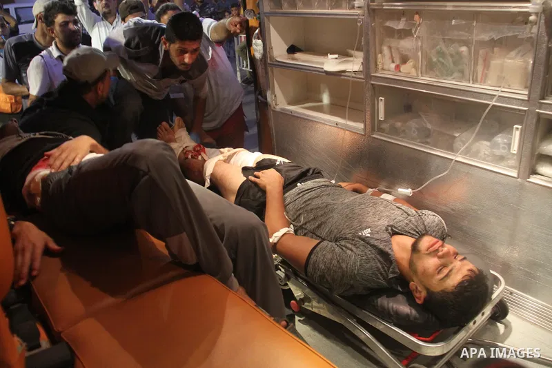 A Palestinian man who was wounded by Israeli troops during clashes at the Israel-Gaza border, in a tent city protest where Palestinians demand the right to return to their homeland, receives treatment at al-Shifa hospita...