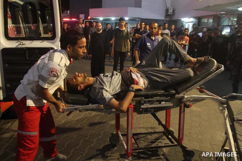 A Palestinian man who was wounded by Israeli troops during clashes at the Israel-Gaza border, in a tent city protest where Palestinians demand the right to return to their homeland, receives treatment at al-Shifa hospita...