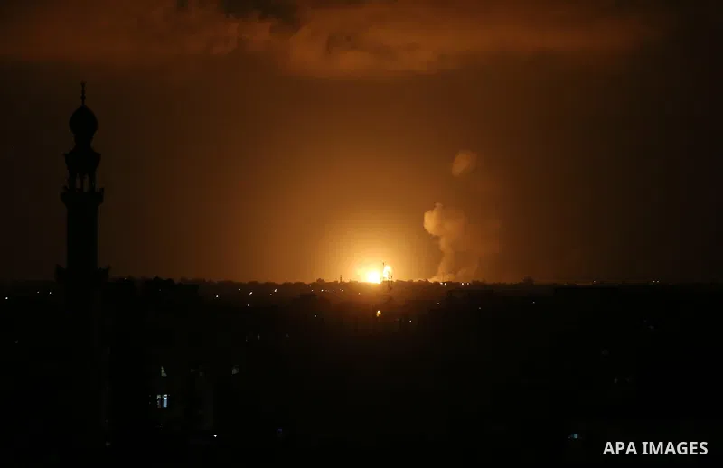 A picture taken on July 20, 2018 shows explosions during an Israeli air strike in Khan Yunis in the southern Gaza Strip. Photo by Ashraf Amra
