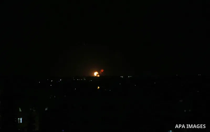 A picture taken on July 20, 2018 shows explosions during an Israeli air strike in Khan Yunis in the southern Gaza Strip. Photo by Ashraf Amra
