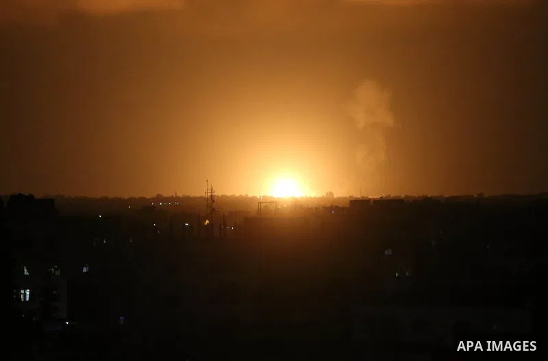 A picture taken on July 20, 2018 shows explosions during an Israeli air strike in Khan Yunis in the southern Gaza Strip. Photo by Ashraf Amra