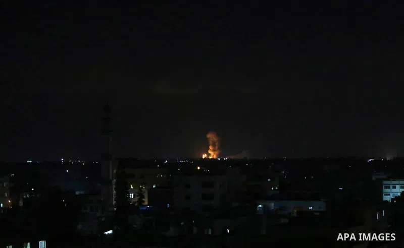 A picture taken on July 20, 2018 shows explosions during an Israeli air strike in Khan Yunis in the southern Gaza Strip. Photo by Ashraf Amra