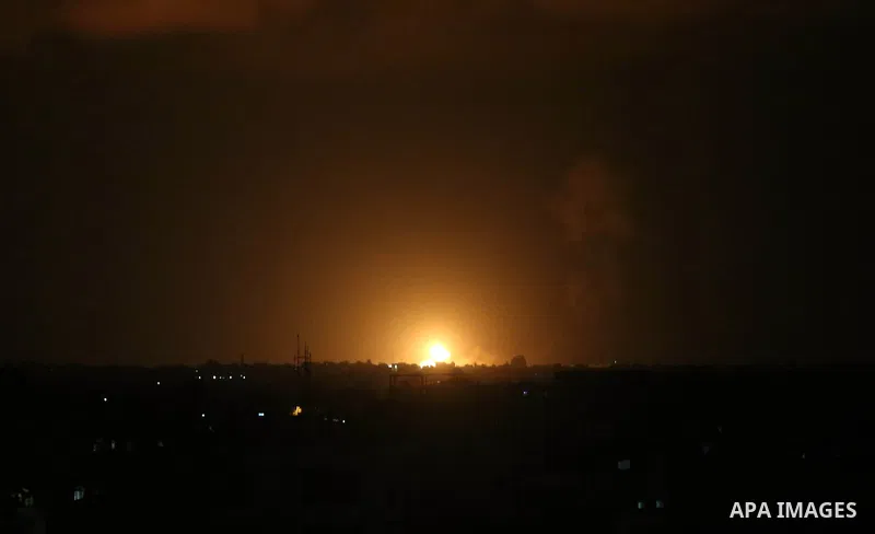 A picture taken on July 20, 2018 shows explosions during an Israeli air strike in Khan Yunis in the southern Gaza Strip. Photo by Ashraf Amra