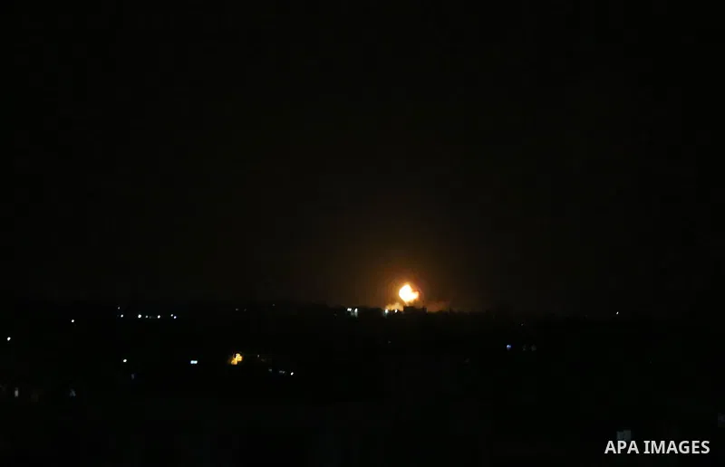 A picture taken on July 20, 2018 shows explosions during an Israeli air strike in Khan Yunis in the southern Gaza Strip. Photo by Ashraf Amra