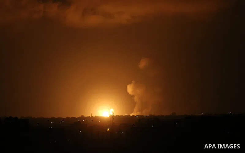 A picture taken on July 20, 2018 shows explosions during an Israeli air strike in Khan Yunis in the southern Gaza Strip. Photo by Ashraf Amra