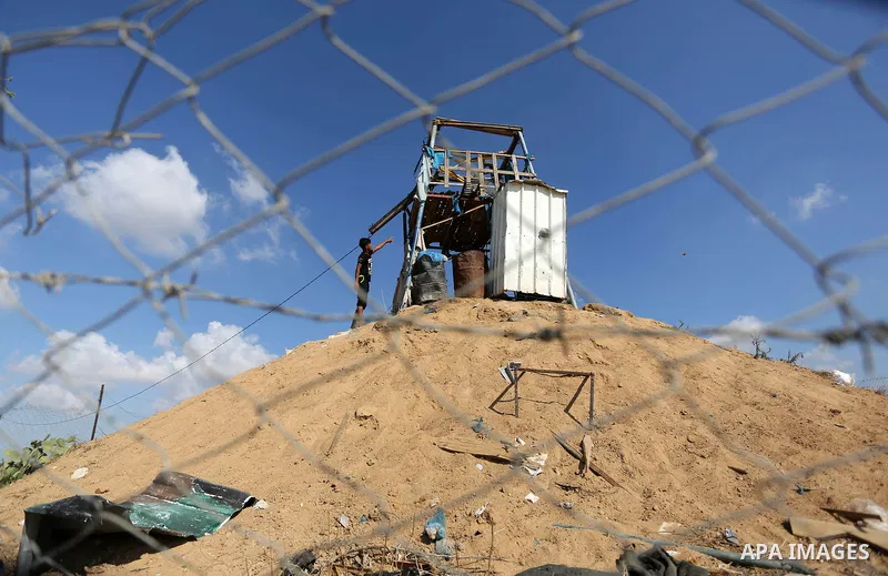 Palestinians inspect a military observation post damaged in an Israeli airstrike in Khan Younis in the southern of Gaza Strip, on July 21, 2018. Photo by Ashraf Amra