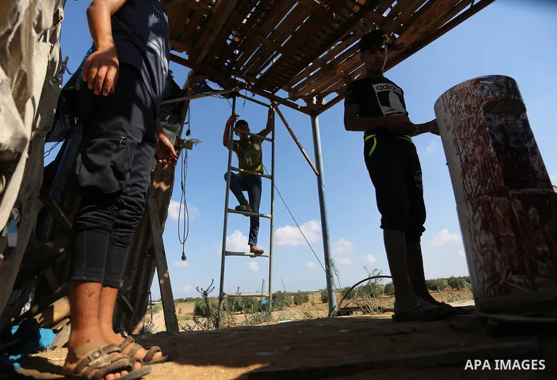 Palestinians inspect a military observation post damaged in an Israeli airstrike in Khan Younis in the southern of Gaza Strip, on July 21, 2018. Photo by Ashraf Amra