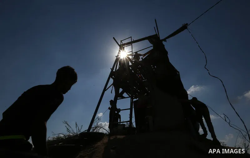 Palestinians inspect a military observation post damaged in an Israeli airstrike in Khan Younis in the southern of Gaza Strip, on July 21, 2018. Photo by Ashraf Amra