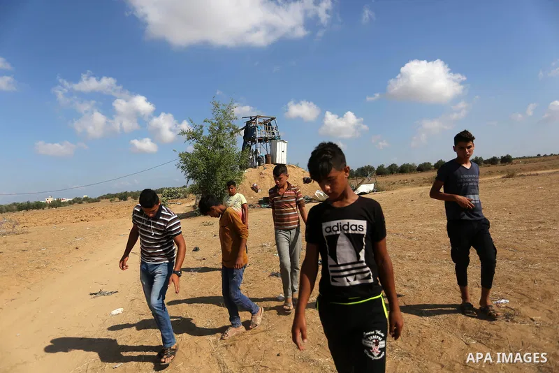Palestinians inspect a military observation post damaged in an Israeli airstrike in Khan Younis in the southern of Gaza Strip, on July 21, 2018. Photo by Ashraf Amra