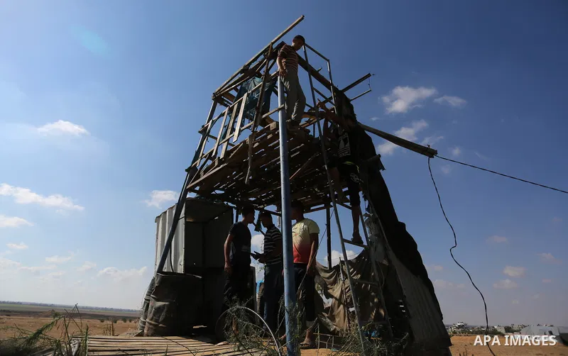 Palestinians inspect a military observation post damaged in an Israeli airstrike in Khan Younis in the southern of Gaza Strip, on July 21, 2018. Photo by Ashraf Amra