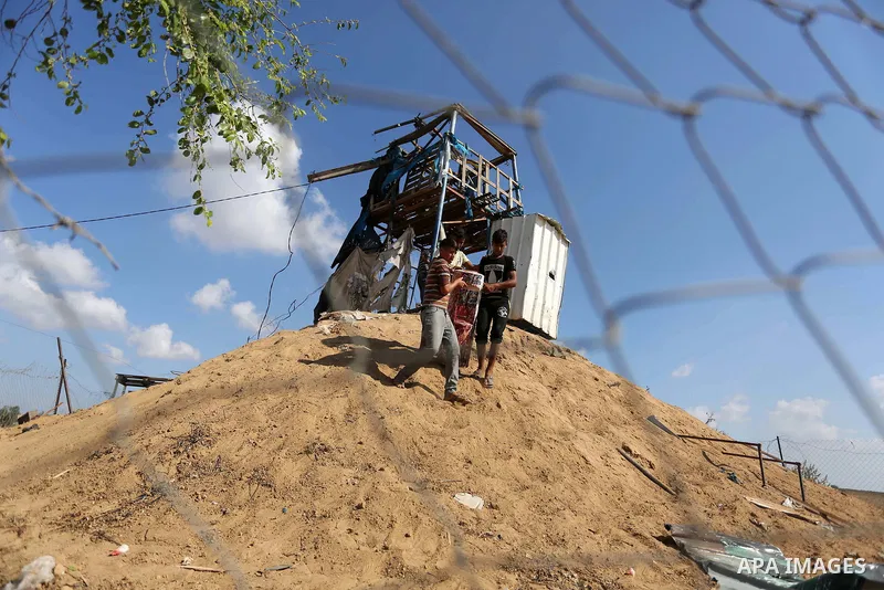 Palestinians inspect a military observation post damaged in an Israeli airstrike in Khan Younis in the southern of Gaza Strip, on July 21, 2018. Photo by Ashraf Amra