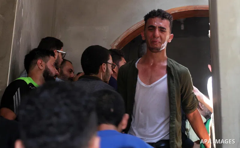 Relatives of Palestinian Mohammed Radwan, who was shot by Israeli forces during clashes at the Israel-Gaza border, mourn during his funeral, in Gaza city on July 21, 2018. Photo by Mahmoud Ajour