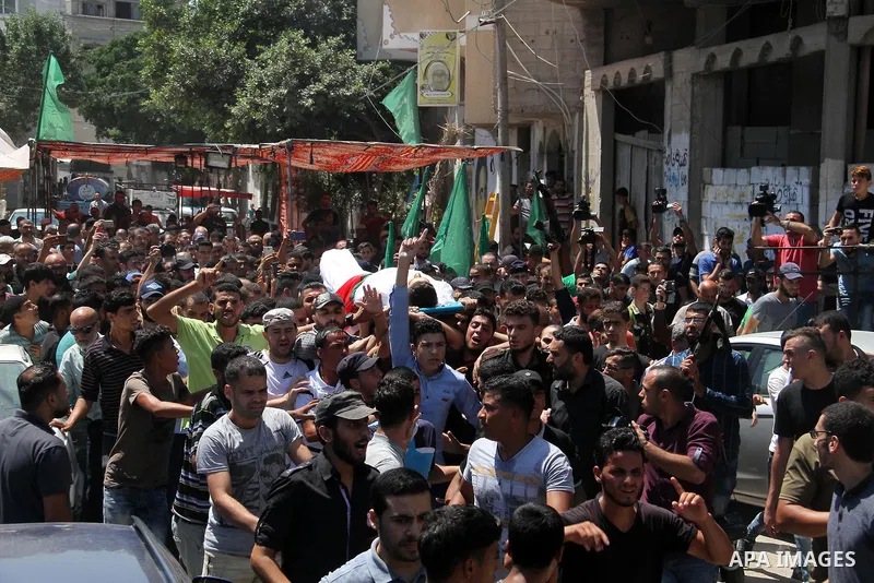 Mourners carry the body of Palestinian Mohammed Radwan, who was shot by Israeli forces during clashes at the Israel-Gaza border, during his funeral, in Gaza city on July 21, 2018. Photo by Mahmoud Ajour