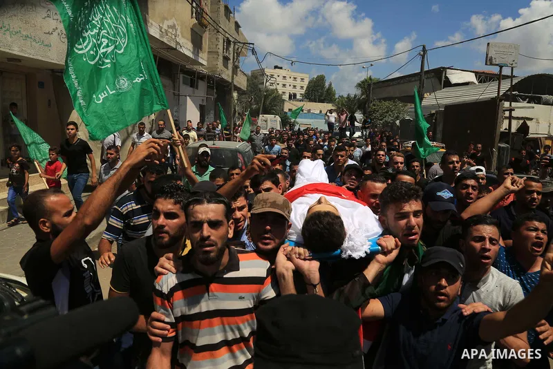 Mourners carry the body of Palestinian Mohammed Radwan, who was shot by Israeli forces during clashes at the Israel-Gaza border, during his funeral, in Gaza city on July 21, 2018. Photo by Dawoud Abo Alkas