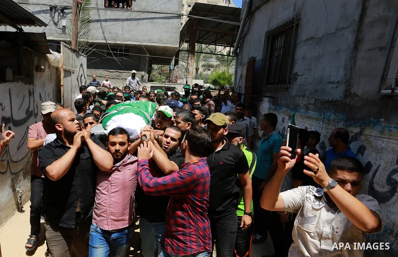 Palestinian mourners carry the body of Ezzedine al-Qassam miltant, Mahmoud Qeshta, who was killed in an Israeli strike, during his funeral in Rafah in the southern of Gaza Strip, on 21 Jul 2018. Israel air strike on Gaza...